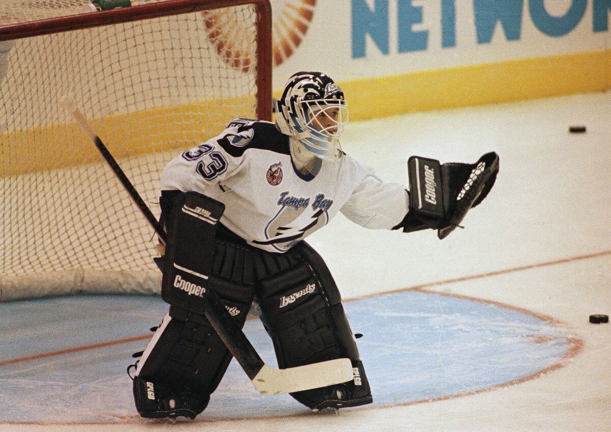 Tampa Bay Lightning goaltender Manon Rheaume uses her glove to save in her pro debut.