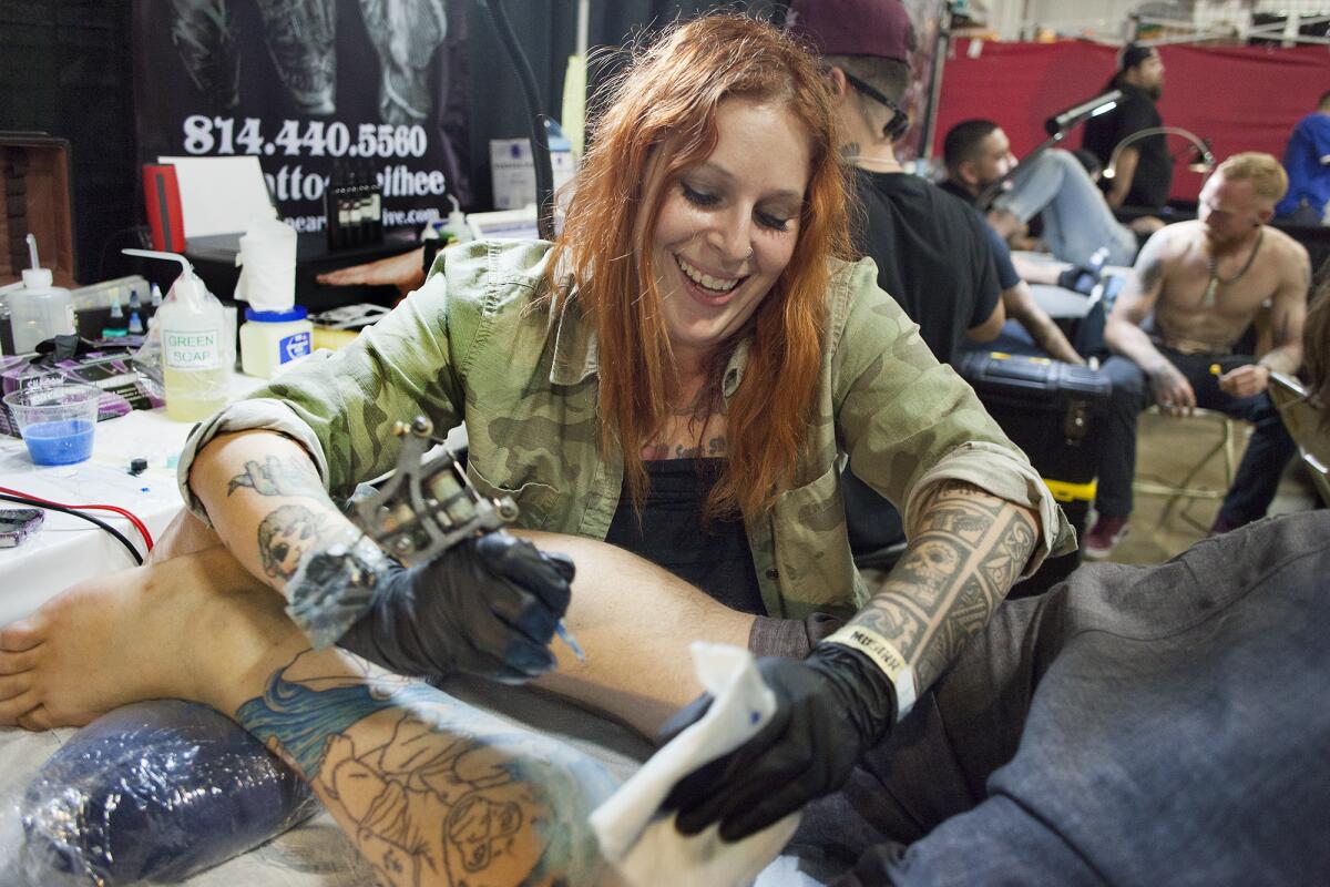 Artist Melissa Daye works on a piece for Cameron Lester of Costa Mesa.