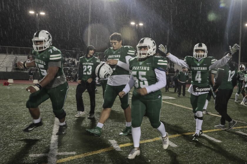 TORRANCE, CA, FRIDAY, DECEMBER 6, 2019 - South Torrance players celebrate as the rain pours down after defeating Canoga Park in a Division 6-AA state bowl game at South Torrance High. (Robert Gauthier/Los Angeles Times)