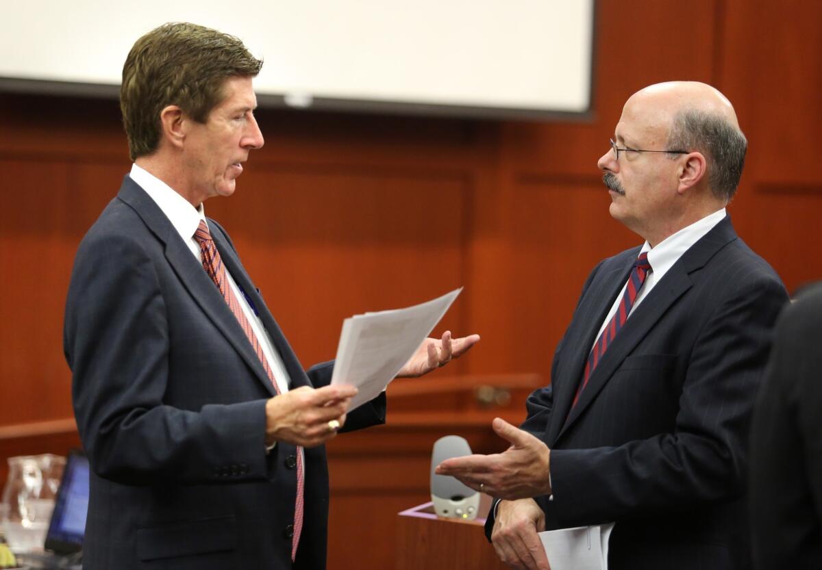 Prosecutor Bernie de la Rionda, right, talks to defense attorney Mark O'Mara in the courtroom in Sanford, Fla. O'Mara is representing George Zimmerman, who is charged with second-degree murder for the 2012 shooting death of 17-year-old Trayvon Martin.