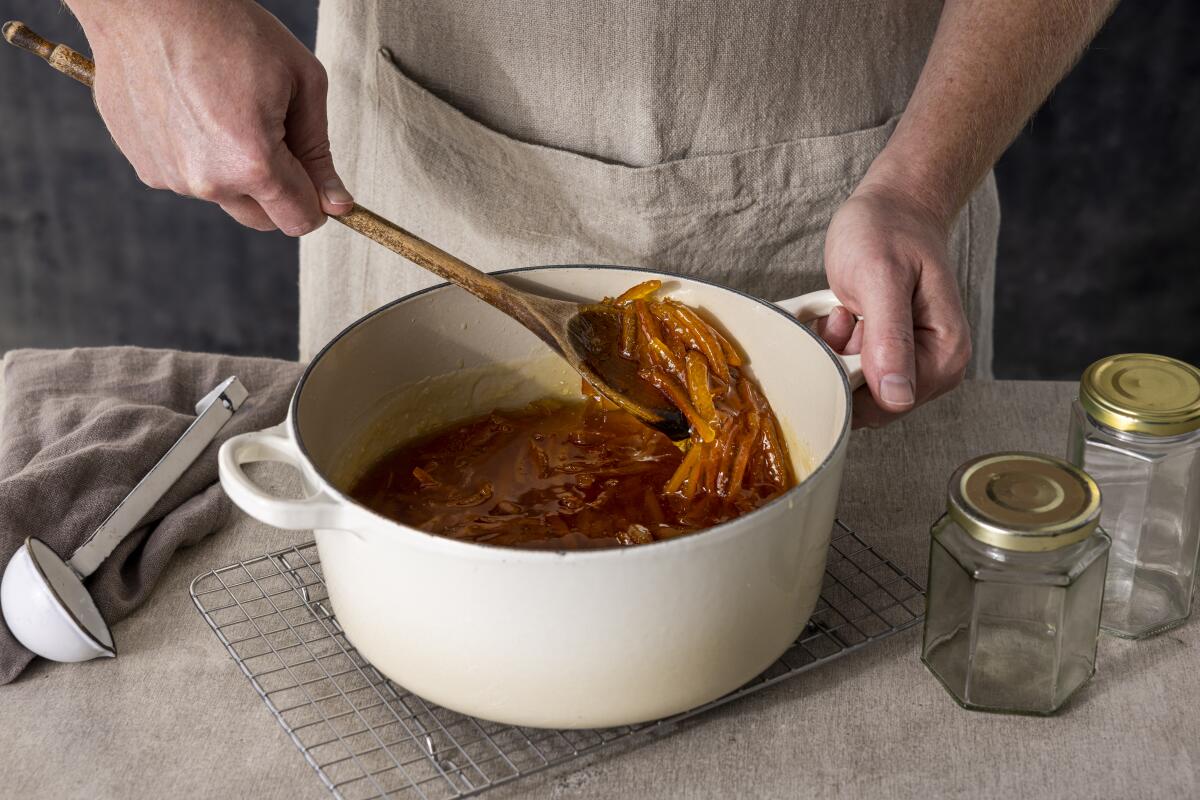 LOS ANGELES, CALIFORNIA, Jan. 19, 2022: Step-by-step citrus marmalade-cooking guide: checking the texture of cooked Sevilles