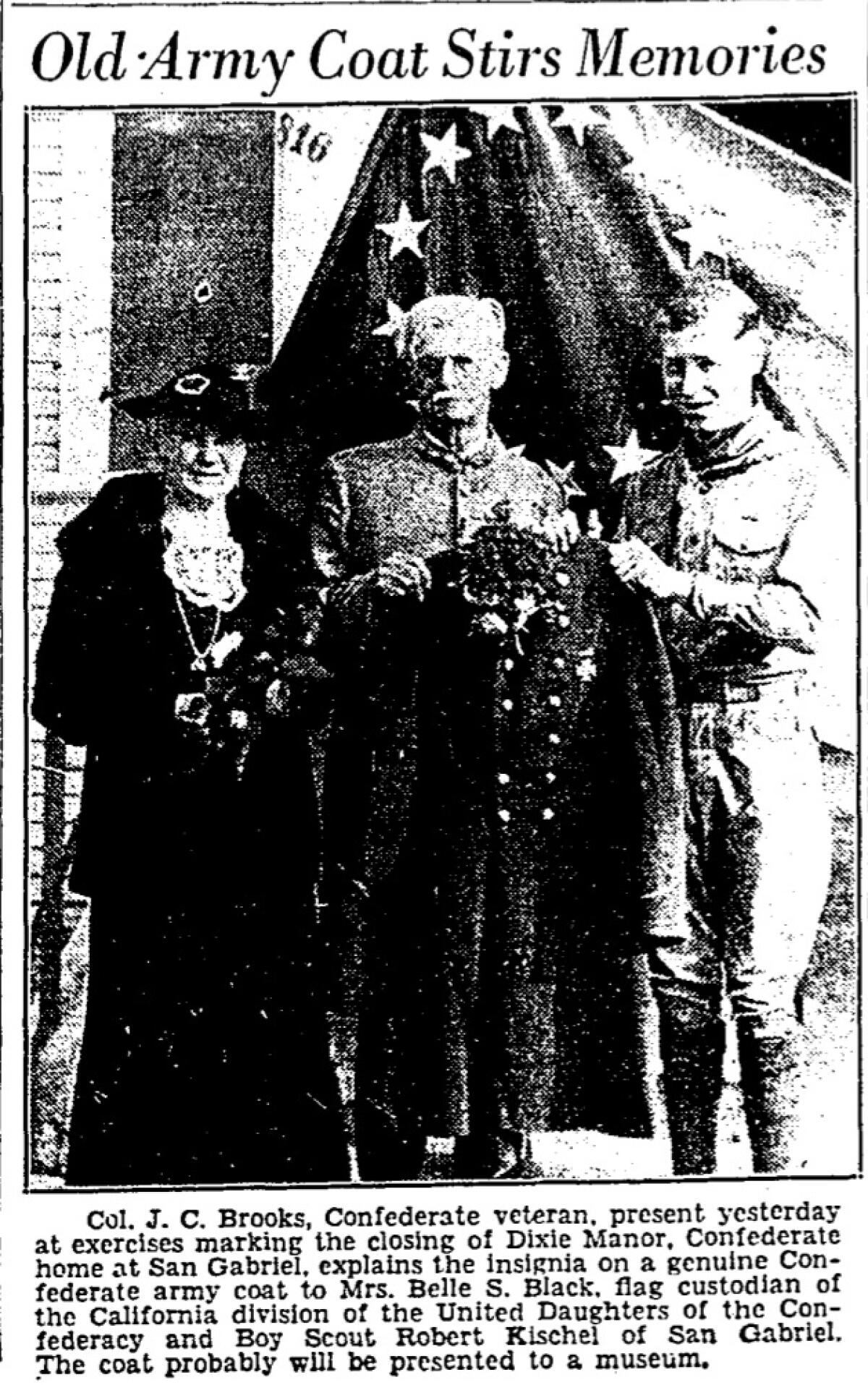 Newspaper clipping. Older man holds military coat, flanked by woman on left and Boy Scout on right.
