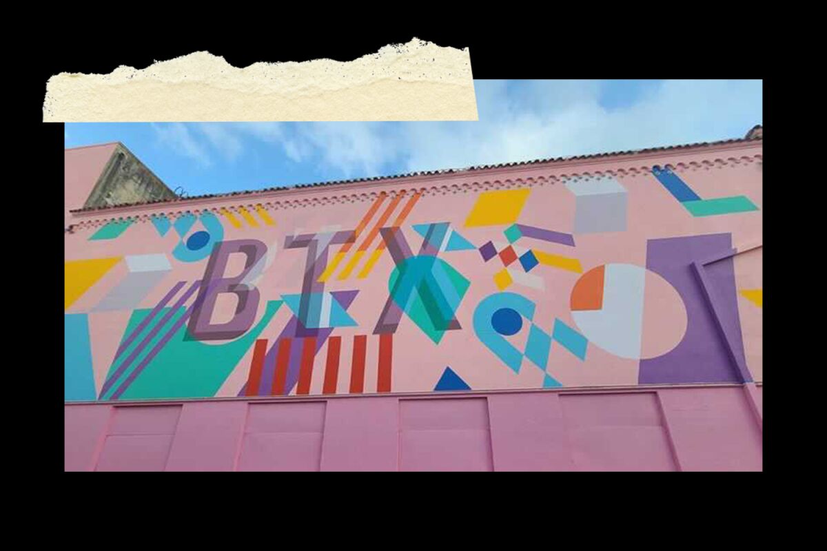 A mural with the letters B T X and colorful geometric shapes