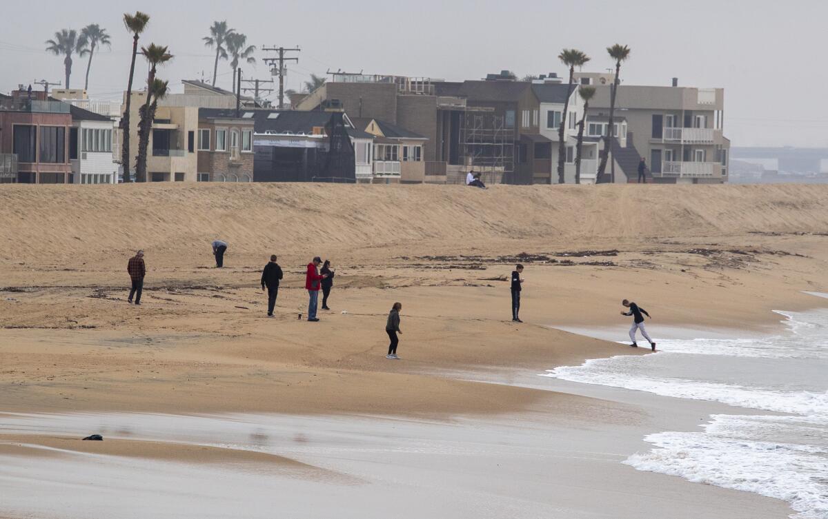 Beachcombers along the shore at Seal Beach are out for the large King Tide hitting the coast this week in Orange County.