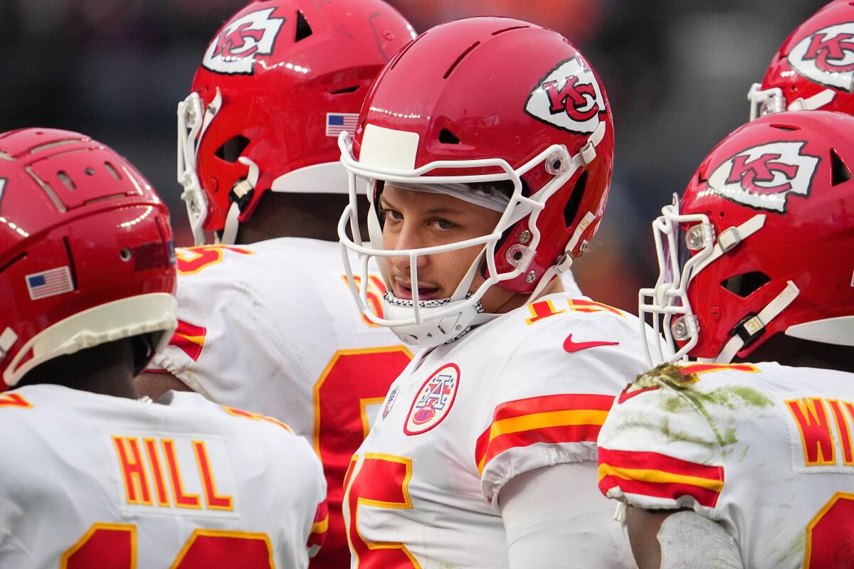 Kansas City Chiefs quarterback Patrick Mahomes talks with teammates before a game against the Denver Broncos.