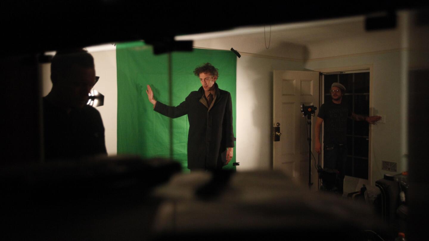 Actor Brian McGuire stands in front of a green screen during filming of a scene for the independent feature "Brain Pickle" in Highland Park. Sound mixer Davin Pressnall, left, and director of photography Rainer Lipski, right, were part of the film crew.