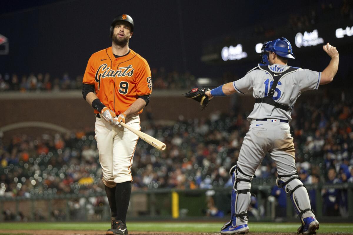 The Giants' Brandon Belt (9) reacts to striking out against the Dodgers.