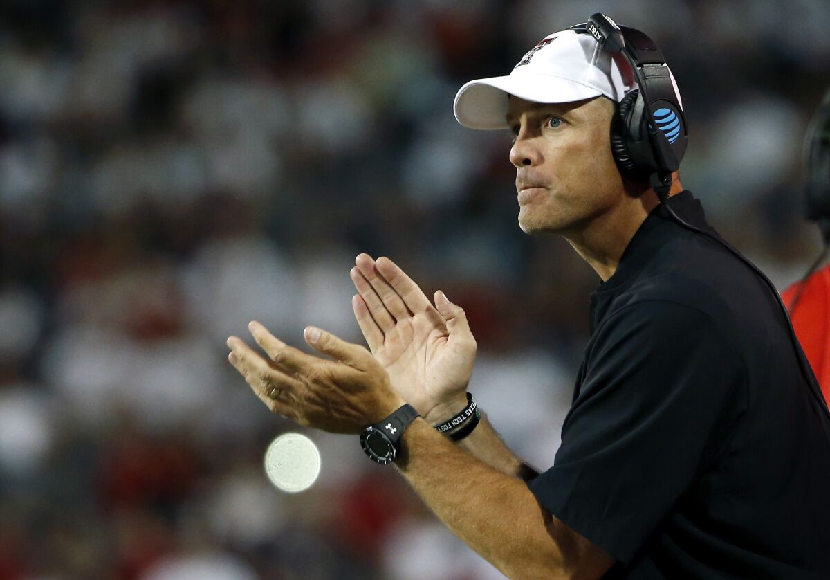 Texas Tech coach Matt Wells applauds his team