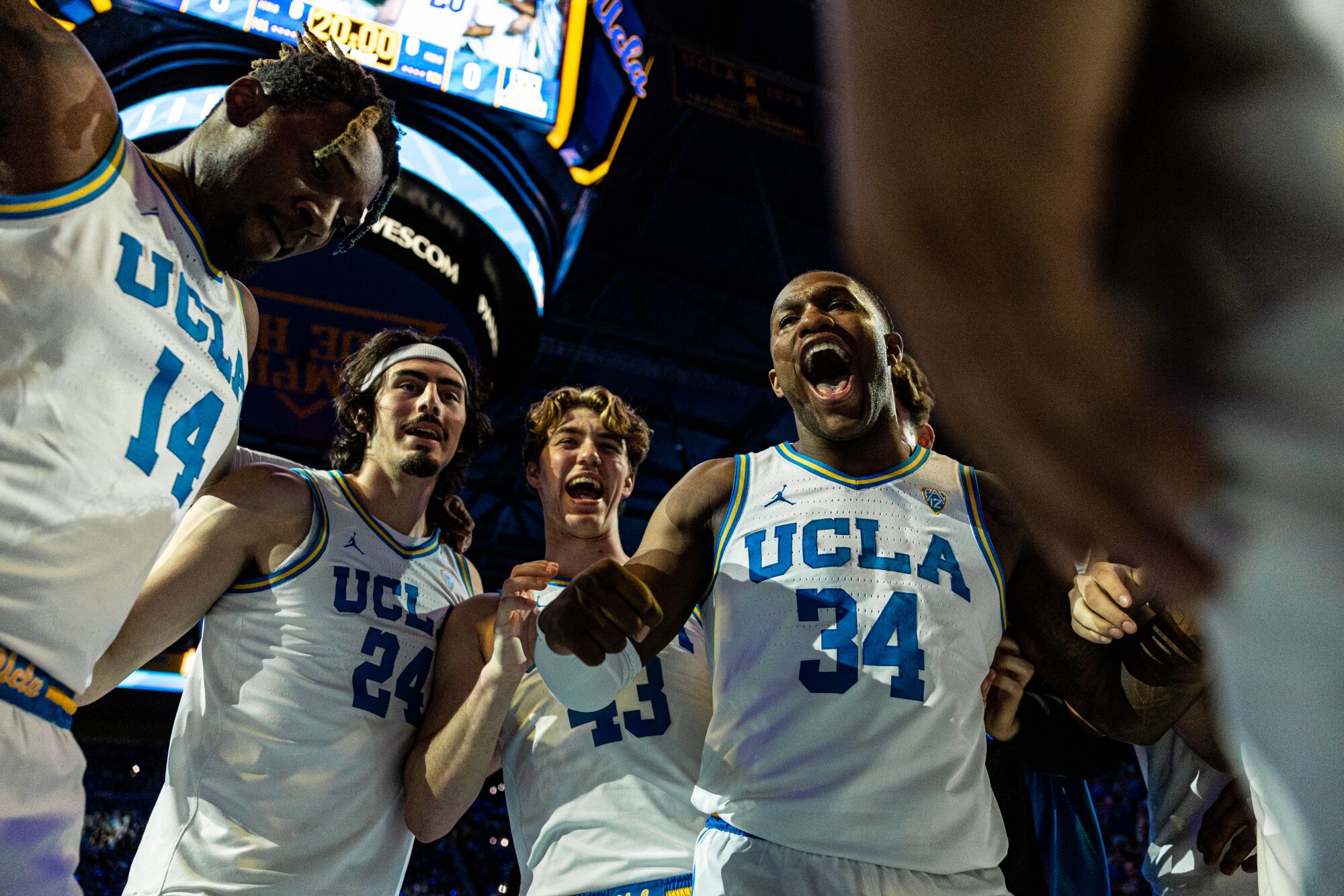 UCLA senior David Singleton (34) takes part in a pregame hype huddle with his teammates before the game against Arizona.