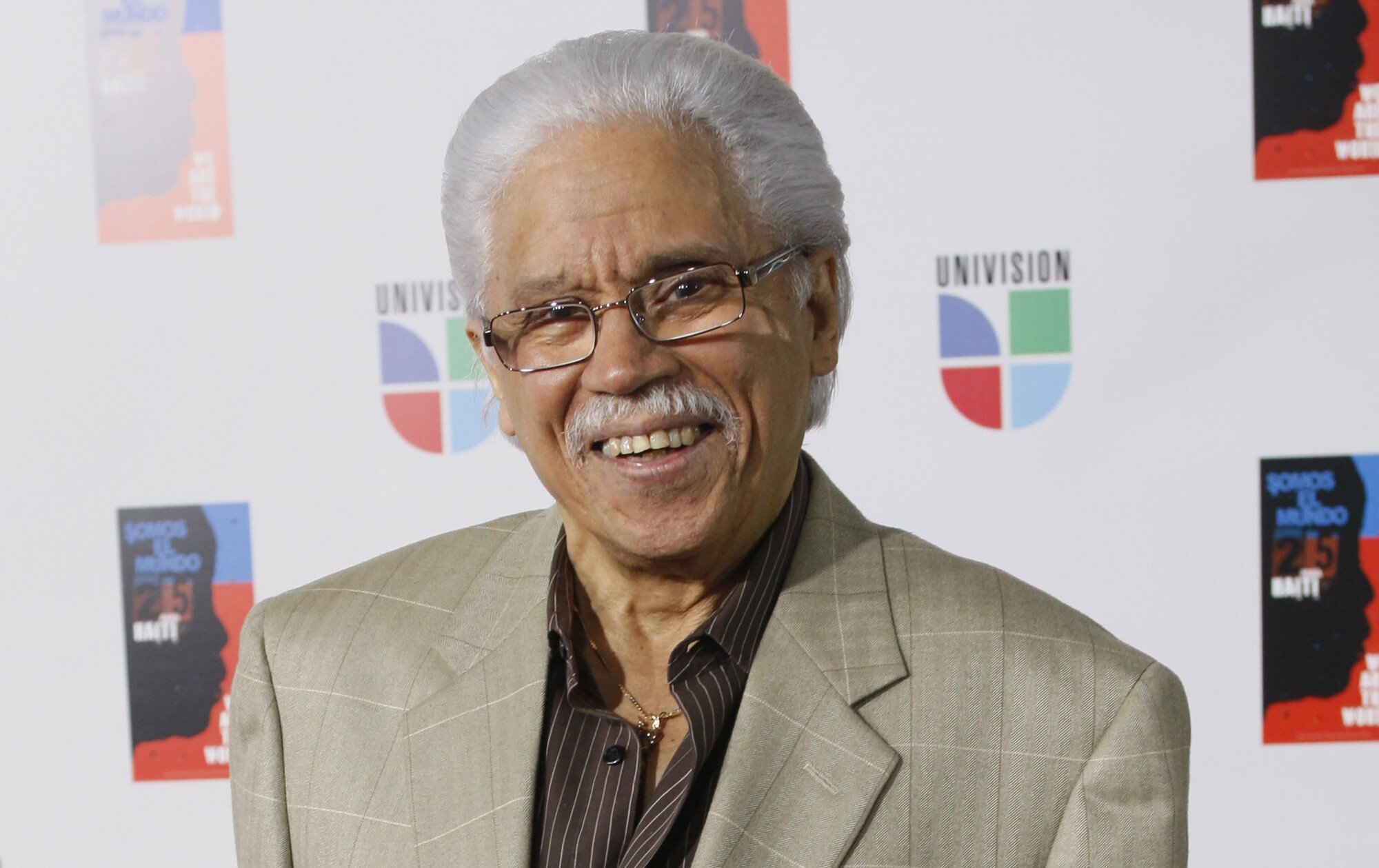 FILE - In this Feb. 19, 2010 file photo, Dominican artist Johnny Pacheco poses for photographers on the red carpet.