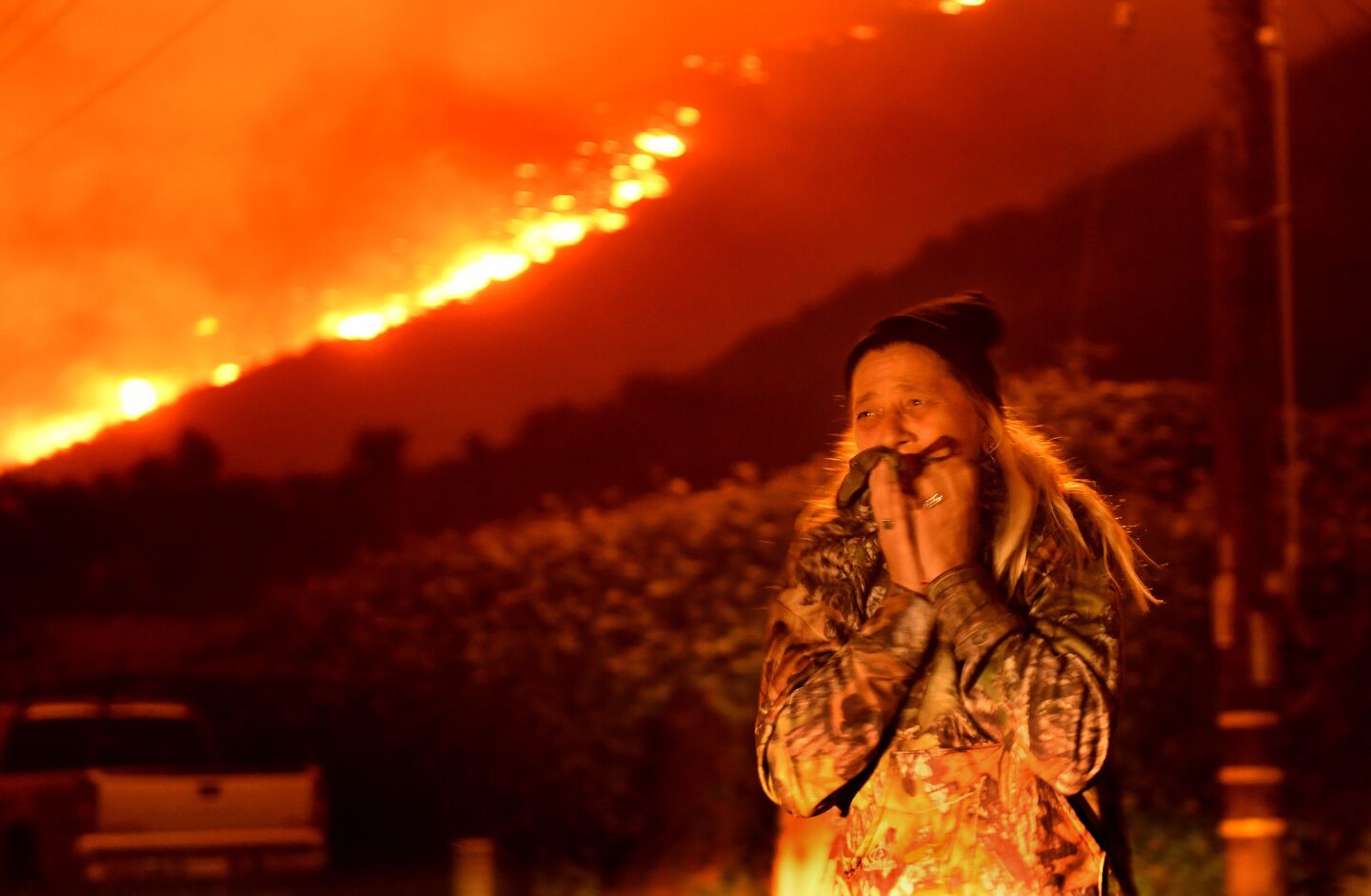 A resident cries as the Thomas fire approaches the town of La Conchita early Thursday.