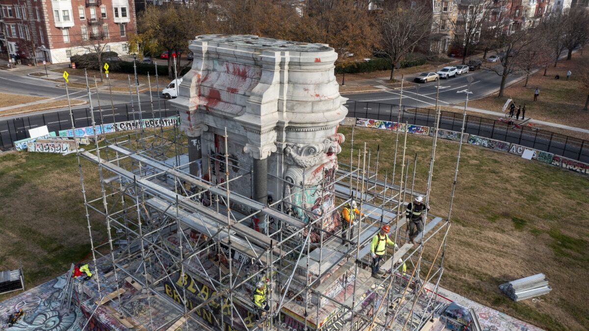 Workers install scaffolding as they prepare to remove the pedestal that once held the statue of Confederate General Robert E. Lee on Monument Avenue Monday Dec 6, 2021, in Richmond, Va. Virginia Gov. Ralph Northam ordered the pedestal removed and the land granted to the City of Richmond. (AP Photo/Steve Helber)