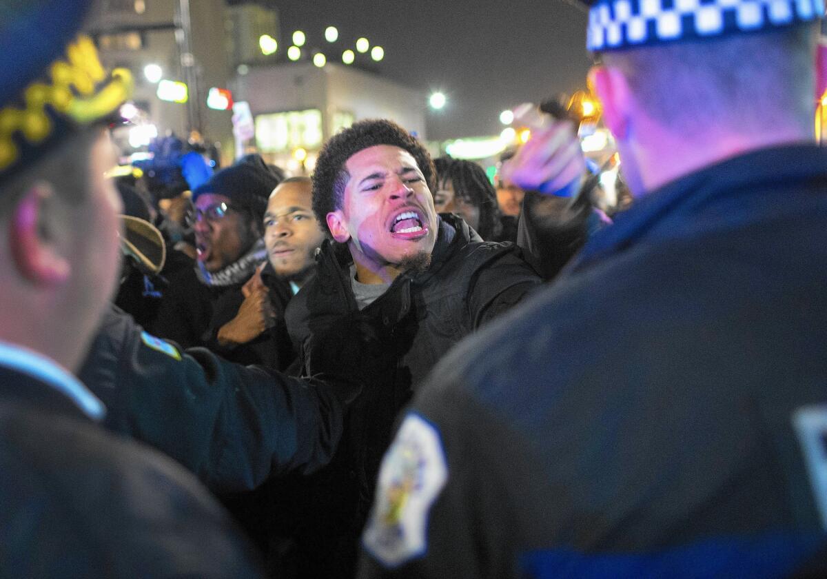 Demonstrators in Chicago confront police after the release of a video showing Officer Jason Van Dyke shooting and killing 17-year-old Laquan McDonald.