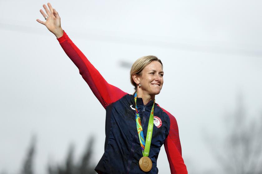Kristin Armstrong of the United States waves on the podium after winning the women's cycling time trial at the Rio Olympics on Aug. 10.