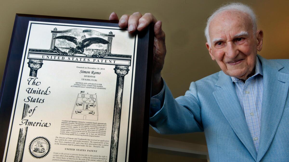 Simon Ramo poses with a mock-up of his final patent, issued to him at age 100 in 2013.