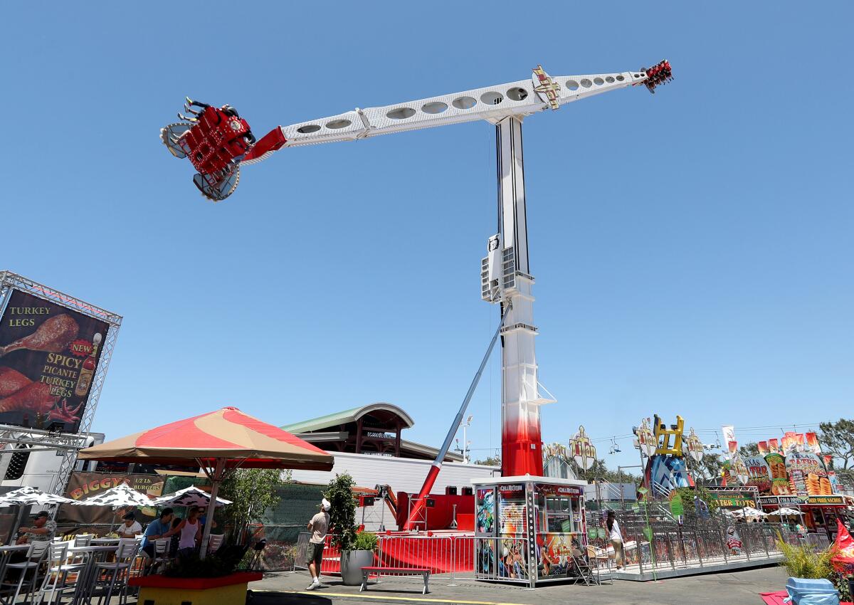 Riders flip as Titan takes them for a high-flying spin at the Orange County Fair in Costa Mesa. Titan is one of four new rides at this year's fair.