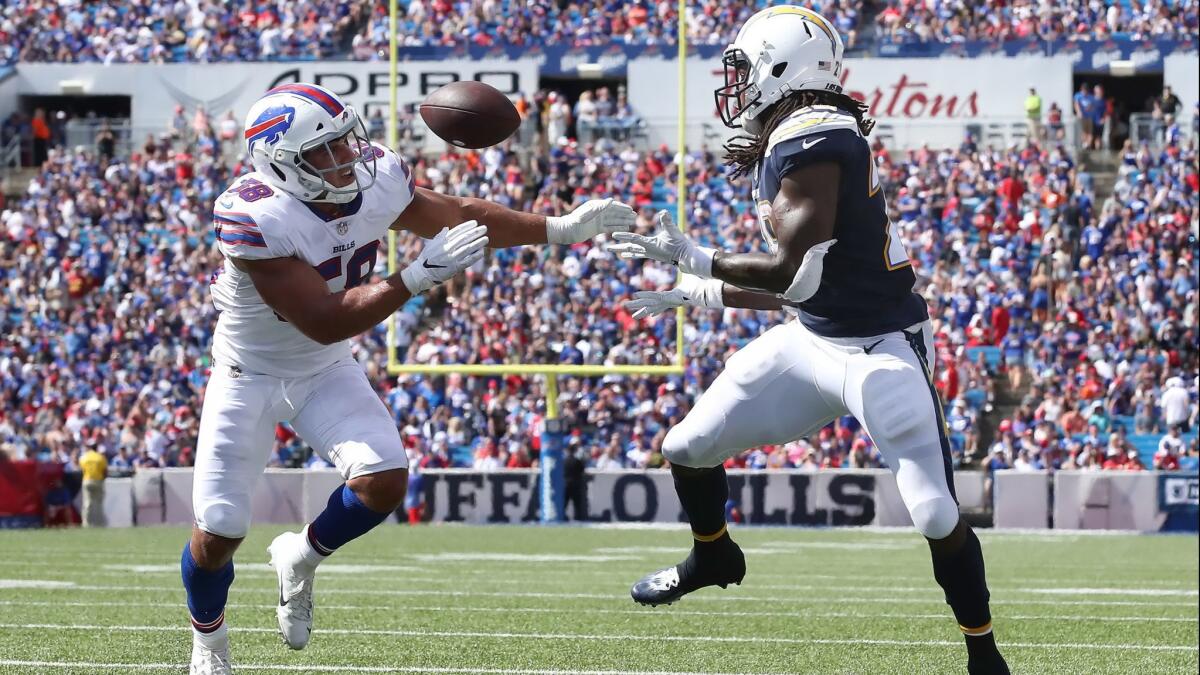 Melvin Gordon catches a touchdown pass while being defended by Buffalo's Matt Milano on Sept. 16.