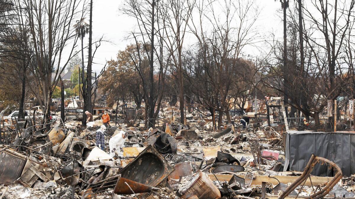 Residents search for salvageable items amid total devastation caused by the Tubbs fire in October 2017.