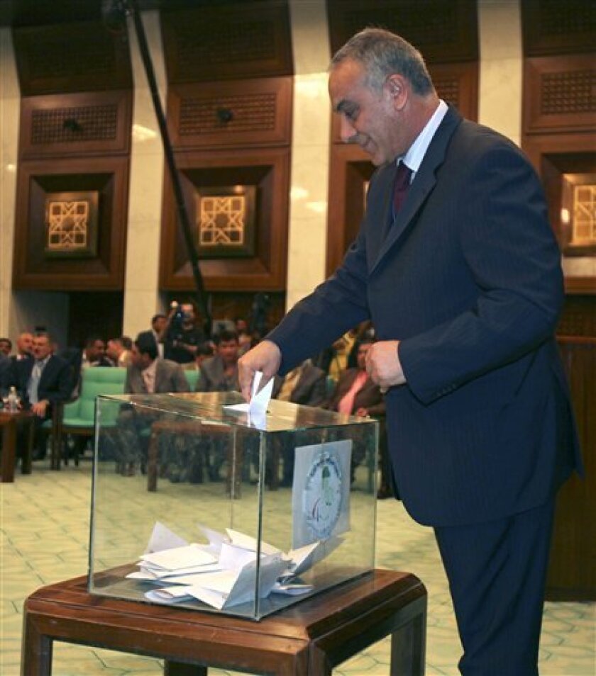 Raad Hamoudi, elected to head the new Iraqi National Olympic committee, casts his ballot for the election of Iraqi National Olympic committee in Baghdad, Iraq, Saturday, April 4, 2009. Hamoudi a well-known goal keeper who led the Iraqi national football team during the 1986 World Cup in Mexico City. (AP Photo/Karim Kadim)