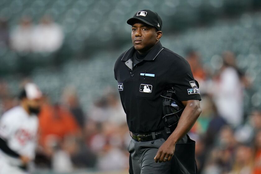 Home plate umpire Malachi Moore looks on during the first inning of a baseball game between the Baltimore Orioles and the Toronto Blue Jays, Wednesday, Sept. 7, 2022, in Baltimore. (AP Photo/Julio Cortez)