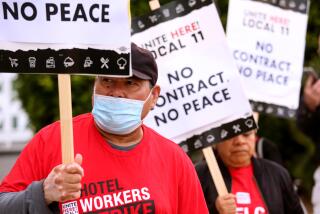 SANTA MONICA, CA - JULY 12, 2023 - Jose Ayala, 66, left, walks the picket line with fellow Unite Here Local 11 hotel workers in front of the Viceroy Hotel in Santa Monica on July 12, 2023. Ayala works as a dishwasher for the Viceroy Hotel and has to work a second job to make ends meet. Some older hotel workers scrape by on their income and can't afford to quit. Some work two jobs just to make ends meet. Unite Here Local 11 hotel employees have been striking for higher pay and better benefits. (Genaro Molina/Los Angeles Times)