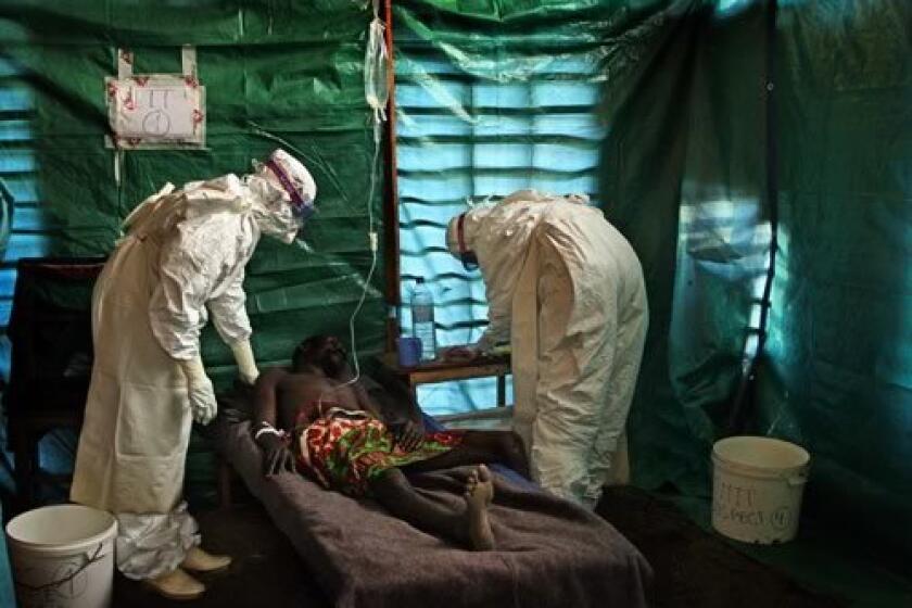 A Doctors Without Borders team checks on a patient suspected of having ebola who is being kept in an isolation ward near Kampungu in the West Kasai province of Congo. Several new cases of the deadly virus have been confirmed in the central region of the Democratic Republic of Congo.