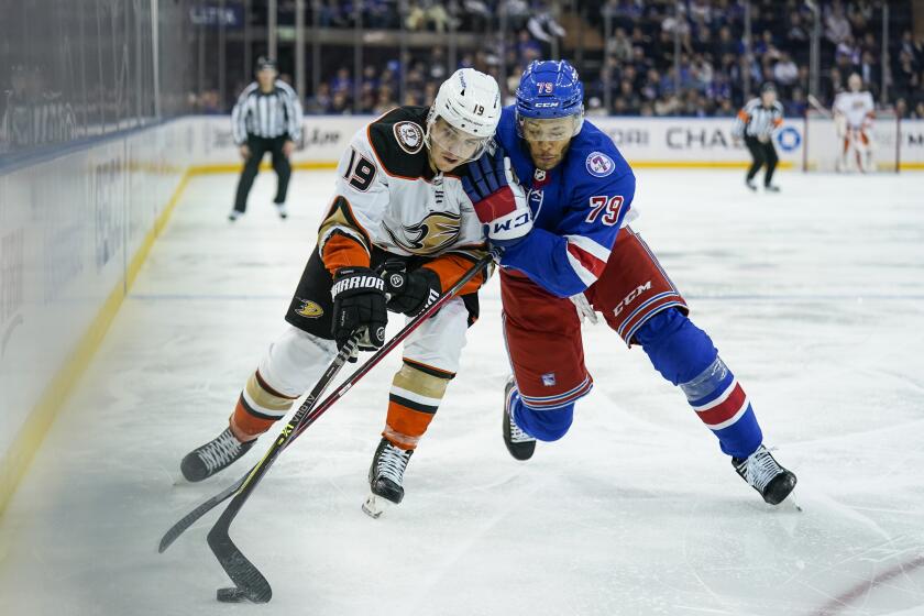 Anaheim Ducks right wing Troy Terry (19) and New York Rangers defenseman K'Andre Miller (79) battle for the puck during the third period of an NHL hockey game, Tuesday, March 15, 2022, in New York. (AP Photo/John Minchillo)