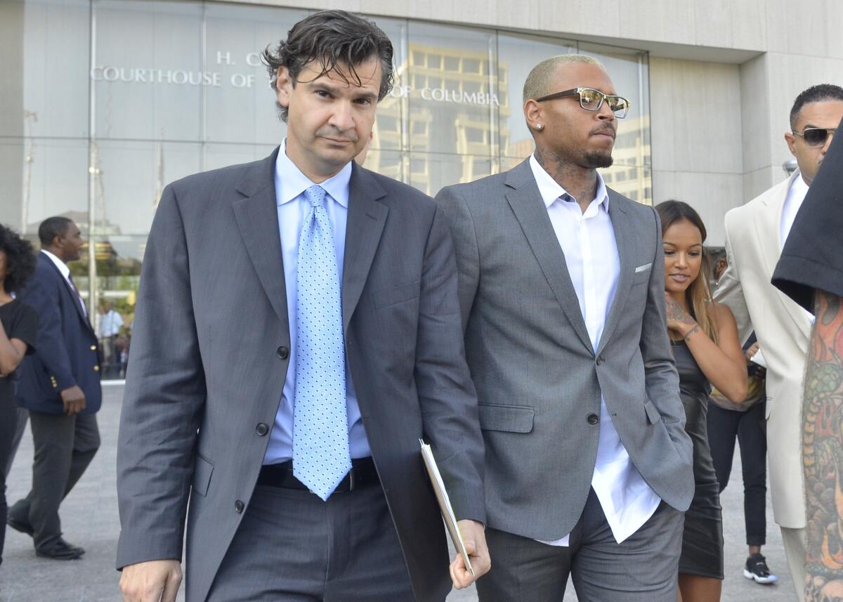 Chris Brown, right, leaves a Washington, D.C., courthouse with lawyer Danny Onorato on Tuesday morning. Brown took a plea deal related to his October assault arrest.