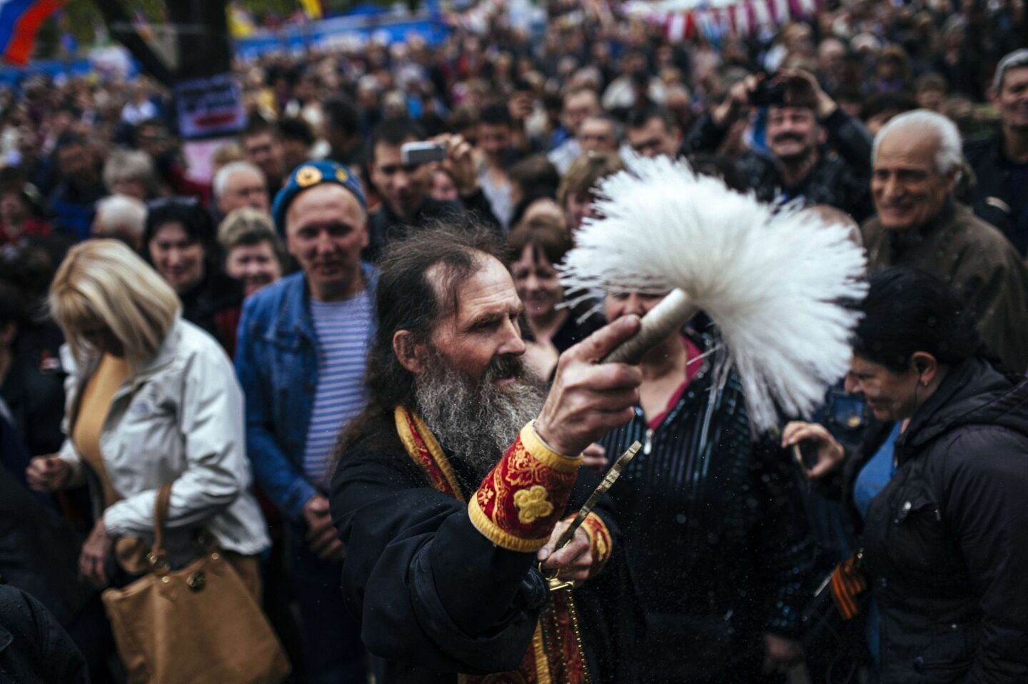An Orthodox priest blesses the crowd at a pro-Russian rally outside the secret service building in the eastern Ukrainian city of Lugansk.