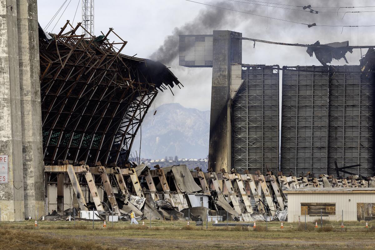 An enormous hangar with fire damage.
