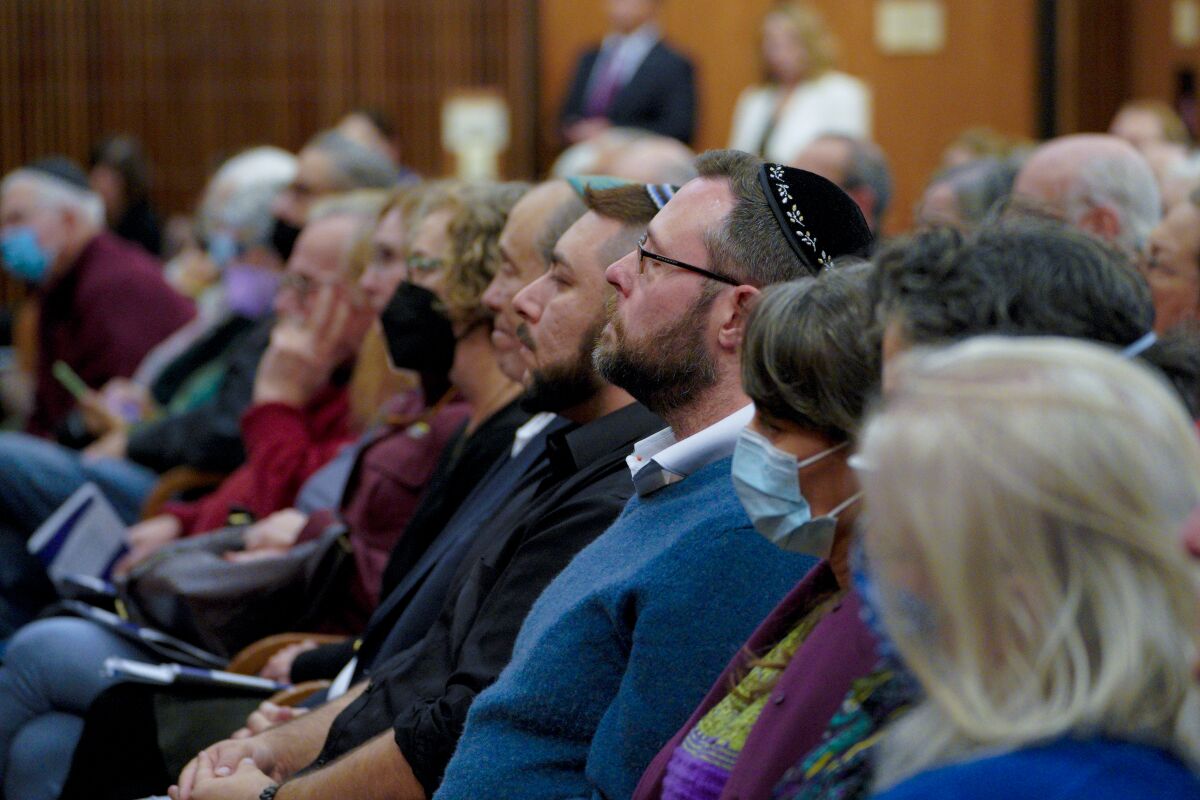 Guest at the Temple Emanu El sat and listened to the panel of panel speakers discussing combating local antisemitism.