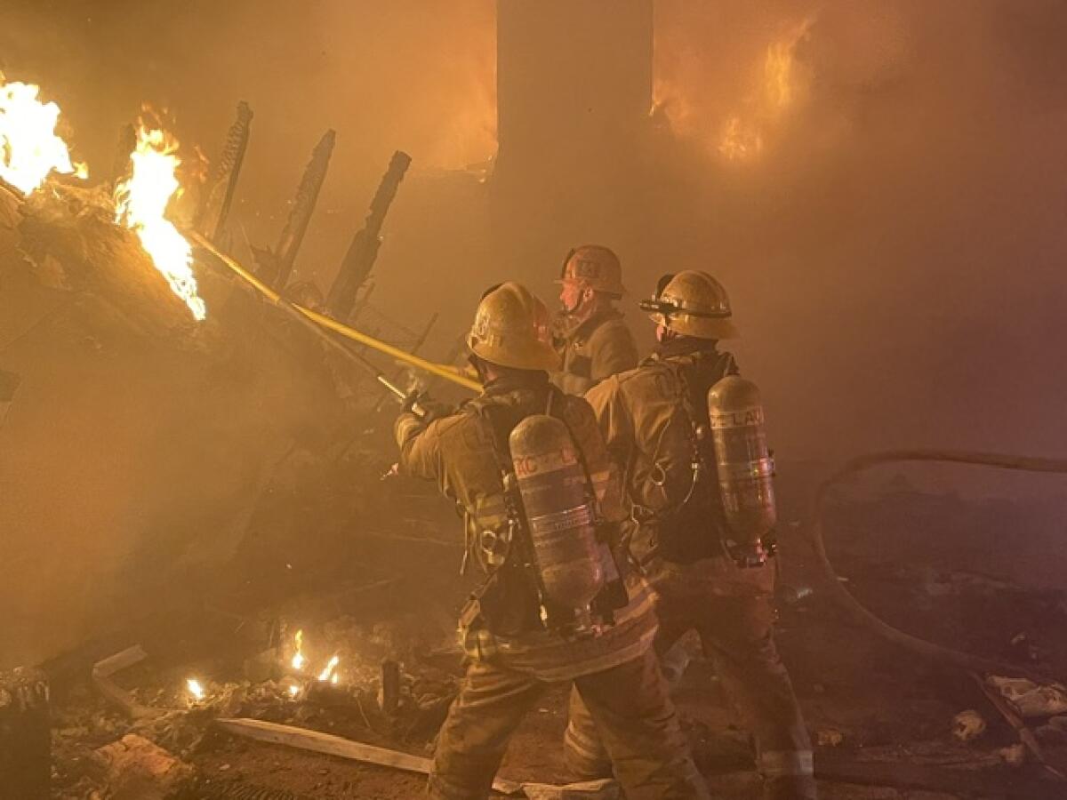 A firefighter battles a structural fire.