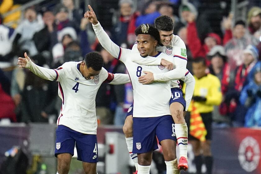 United States' Weston McKennie celebrates his goal with Tyler Adams, left, and Christian Pulisic.