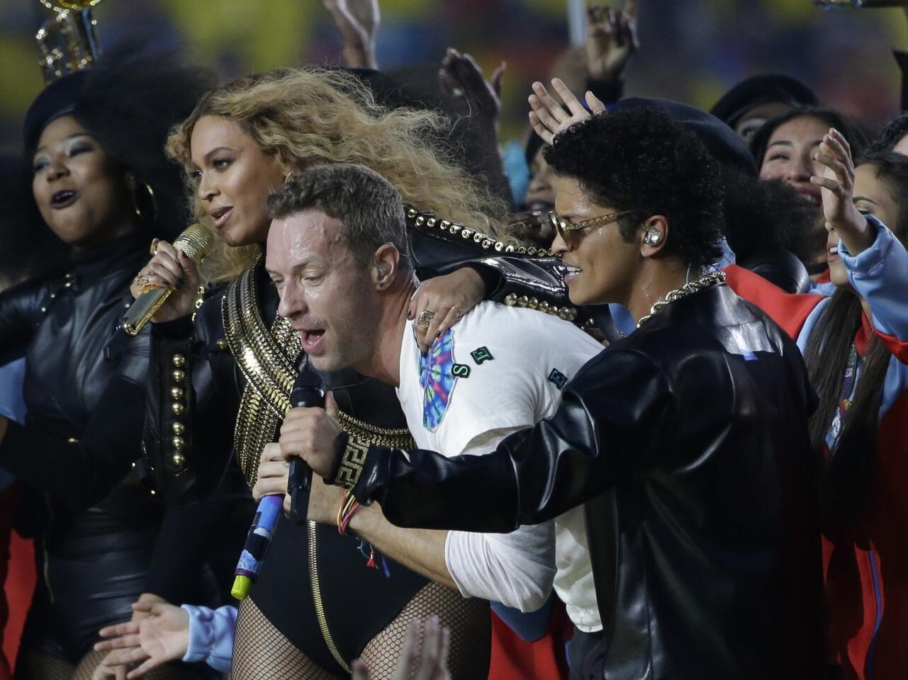 Coldplay singer Chris Martin performs with Beyonce and Bruno Mars during halftime of the NFL Super Bowl 50 football game Sunday, Feb. 7, 2016. AP Photo/Marcio Jose Sanchez