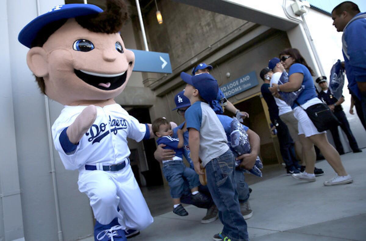 Jake Justin, a 4-year-old from Santa Clarita, meets the Dodgers' performance character before a game at Dodger Stadium on Tuesday.