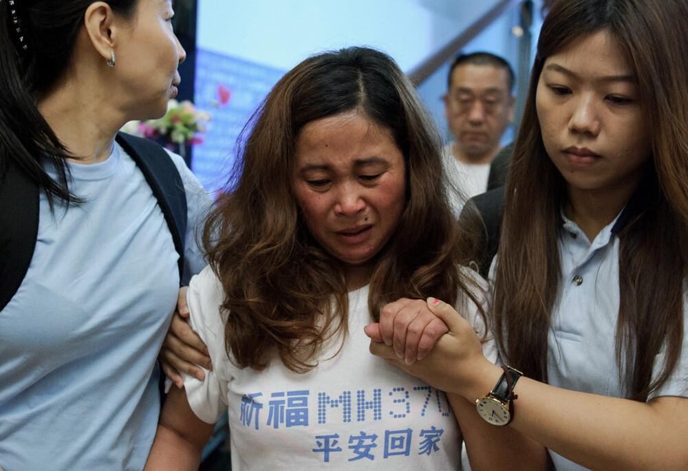 A Chinese relative cries as she leaves after offering prayers for passengers onboard missing Malaysia Airlines flight MH370 in Kuala Lumpur, Malaysia, on April 6.