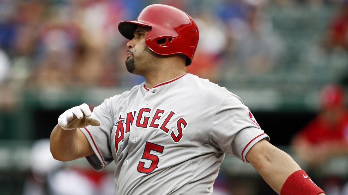 Angels first baseman Albert Pujols follows through on a home run against the Texas Rangers on Aug. 16. Pujols has been healthy and productive for the Angels this season.
