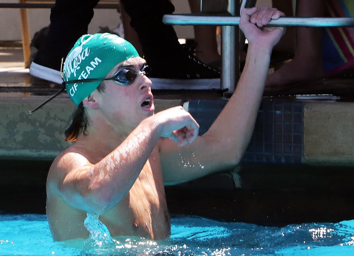 Costa Mesa's Wes Brasda reacts after winning the Division 3 boys' 200 yard medley relay on Saturday.