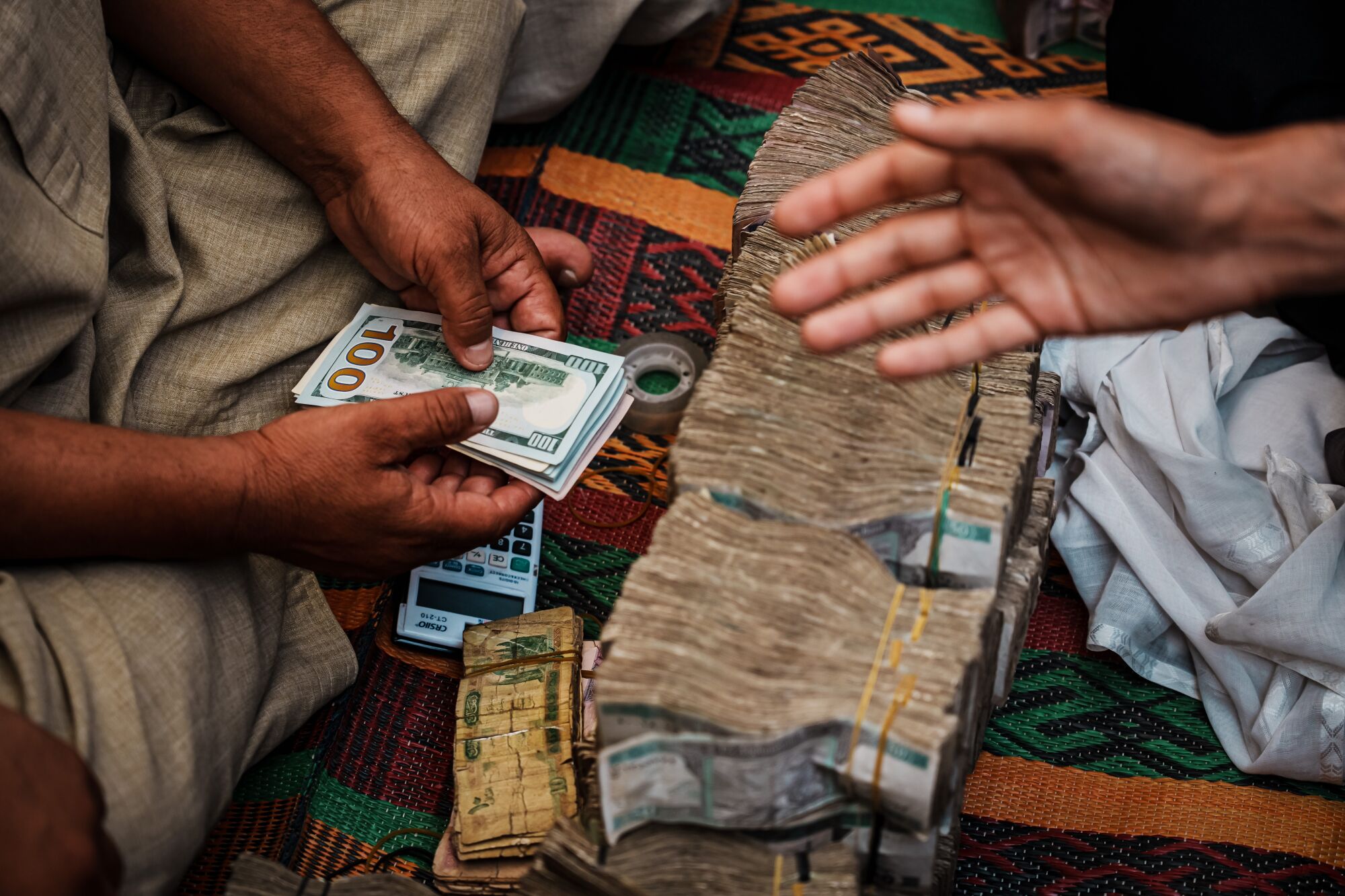 Currency trader holding wad of U.S. banknotes