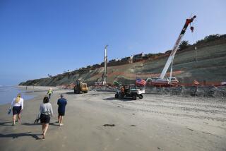 SAN DIEGO, CA - SEPTEMBER 16: Construction continues on a 300-foot-long seawall to protect the coastal bluffs below the heavily travelled railroad tracks near Fourth Street in Del Mar on Thursday, Sept. 16, 2021. Steel piles are being installed to shore up the bluff which collapsed in February. (K.C. Alfred / The San Diego Union-Tribune)