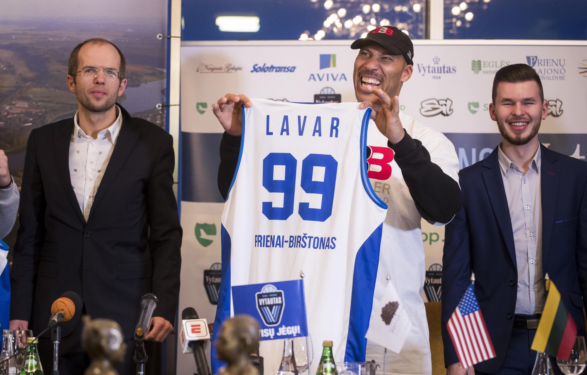 LaVar Ball holds up a Lytautas Prienai jersey during a news conference in Lithunia.