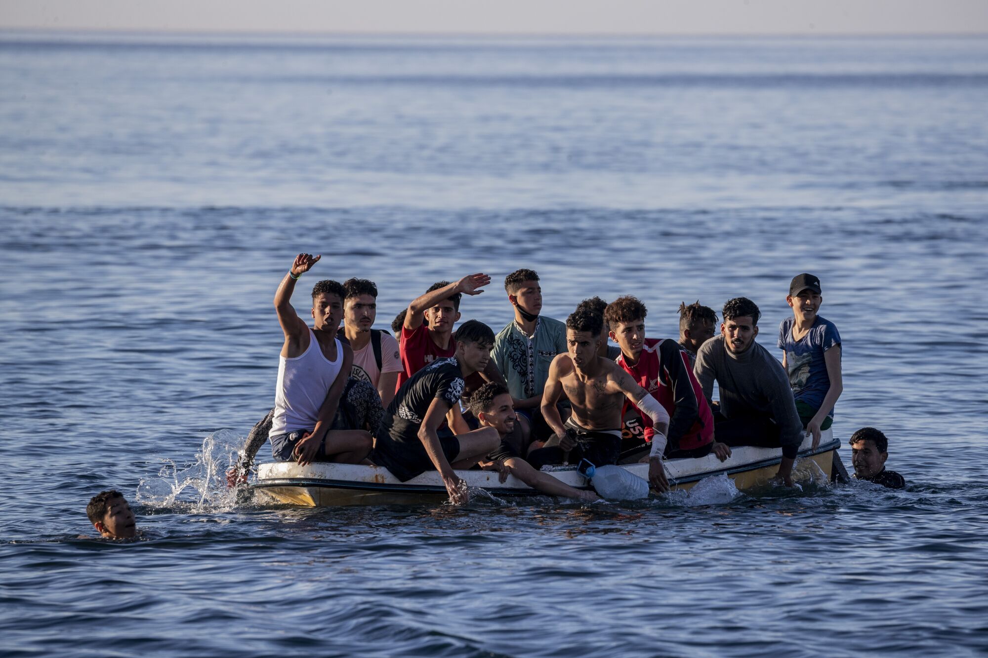 A small boat overloaded with more than a dozen young men and boys