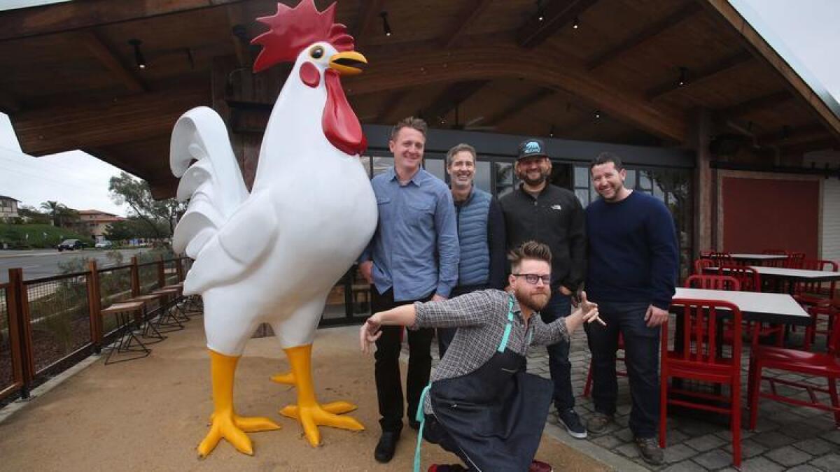 Chef/partner Richard Blais, foreground, gets down with the Crack Shack chicken at the new Encinitas location with, from left, manager Dan Pena, owner Mike Rosen, executive chef Jon Sloan and development director Joshua Lichtman.