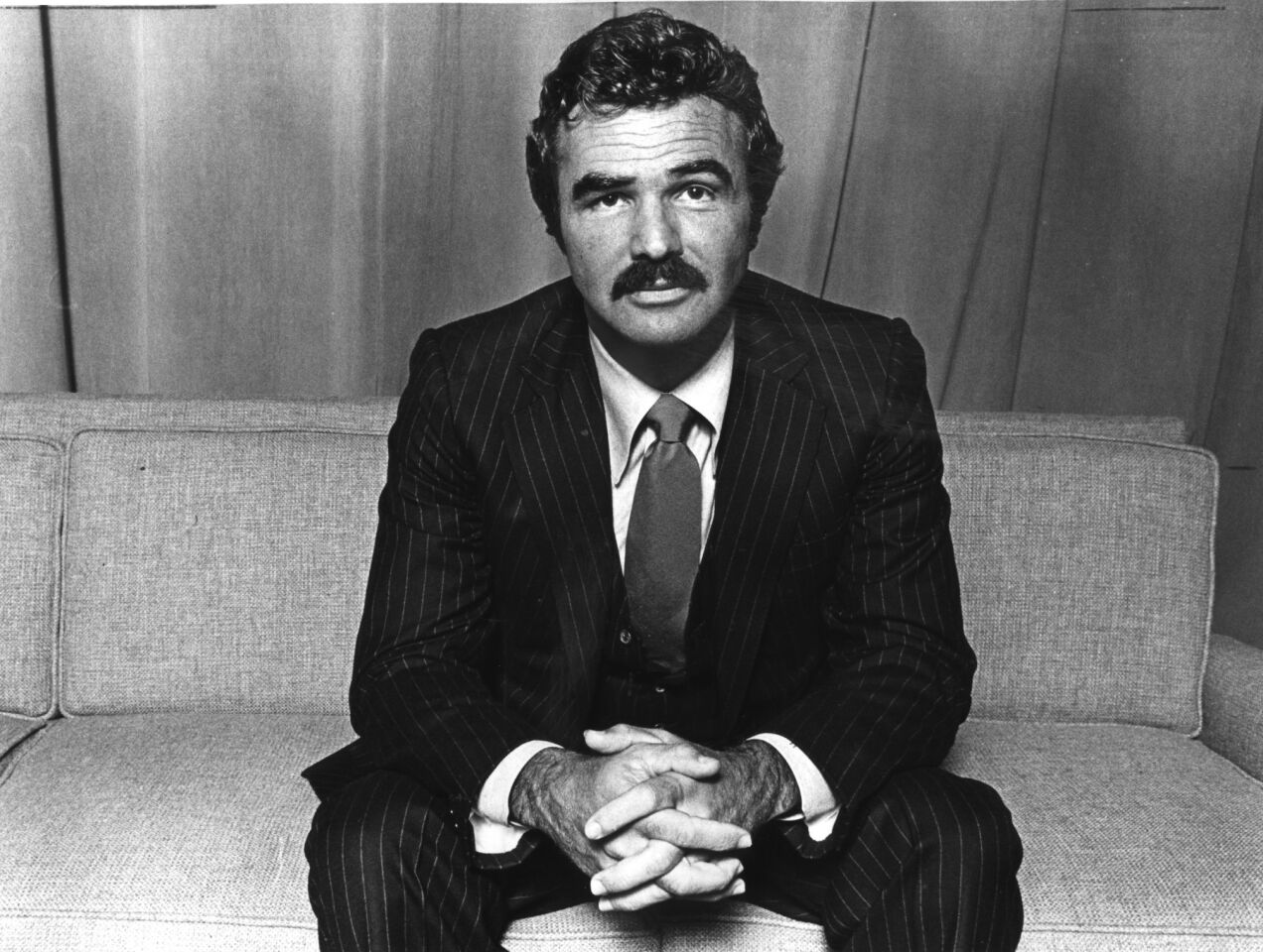 Burt Reynolds sits for a photo as he receives an award at UCLA in 1980.