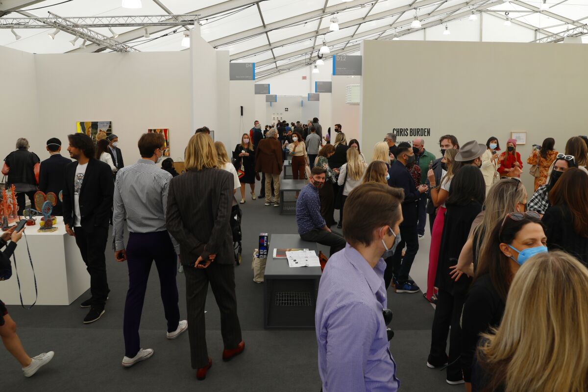 Attendees mill around booths at Frieze LA