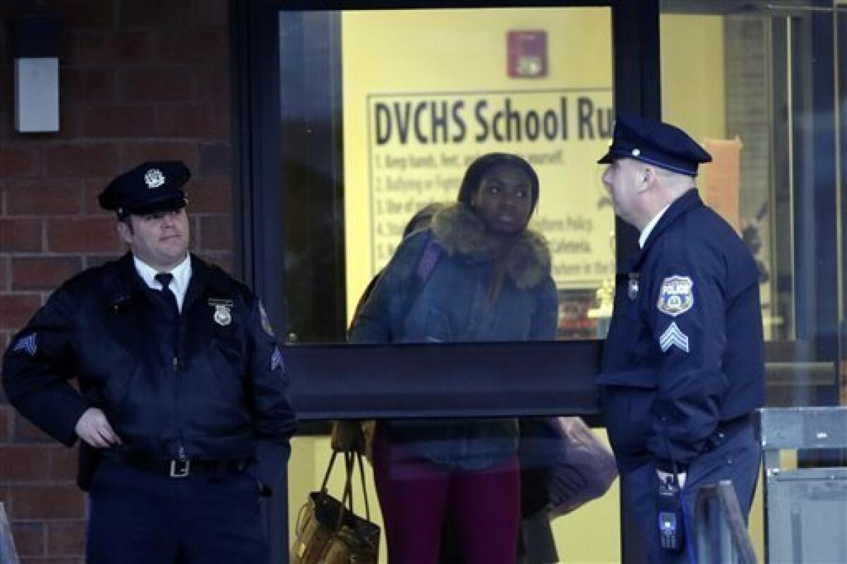 Students leave Delaware Valley Charter High School in Philadelphia after two students were shot in the arm.