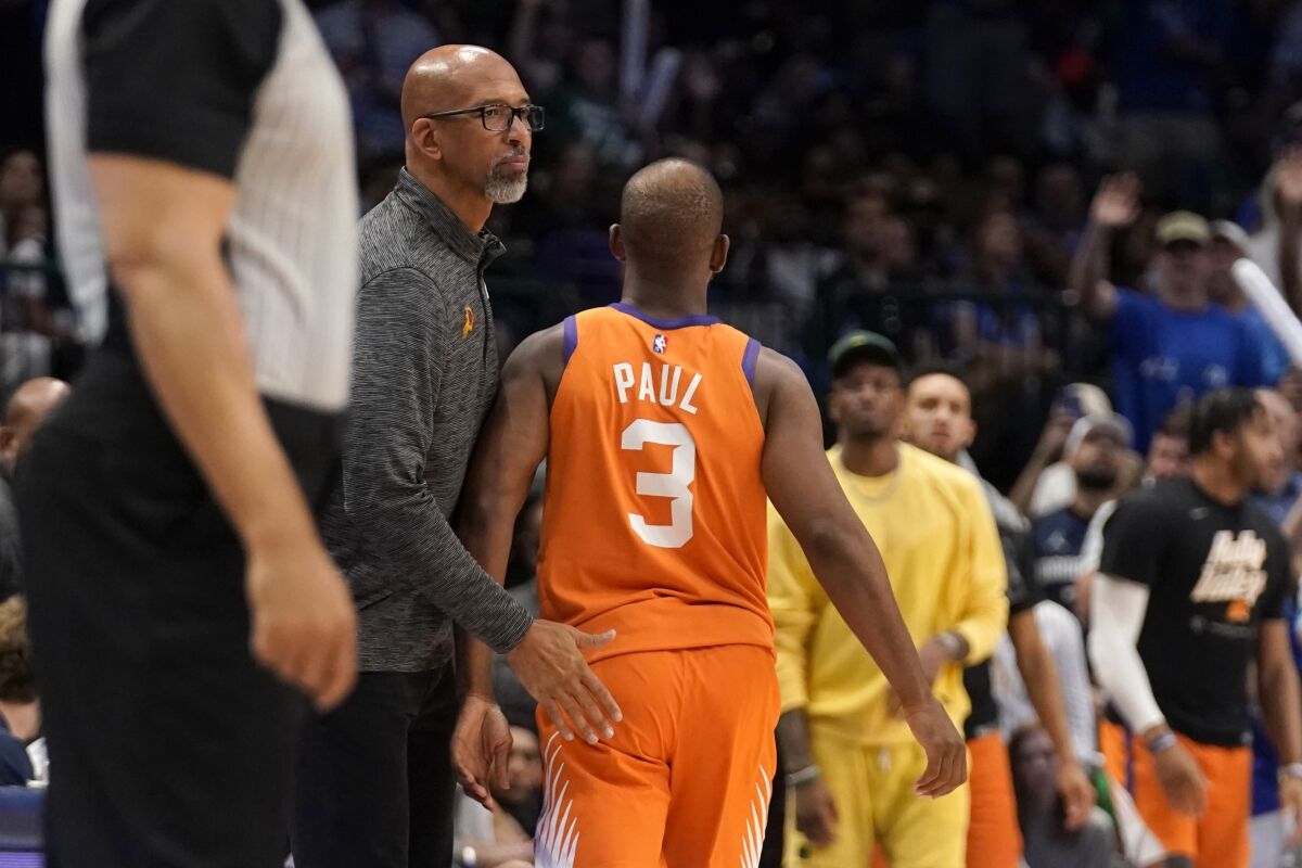 Phoenix Suns head coach Monty Williams, left, greets, Chris Paul (3) at the bench after Paul fouled out in the second half of Game 4 of an NBA basketball second-round playoff series against the Dallas Mavericks, Sunday, May 8, 2022, in Dallas. (AP Photo/Tony Gutierrez)
