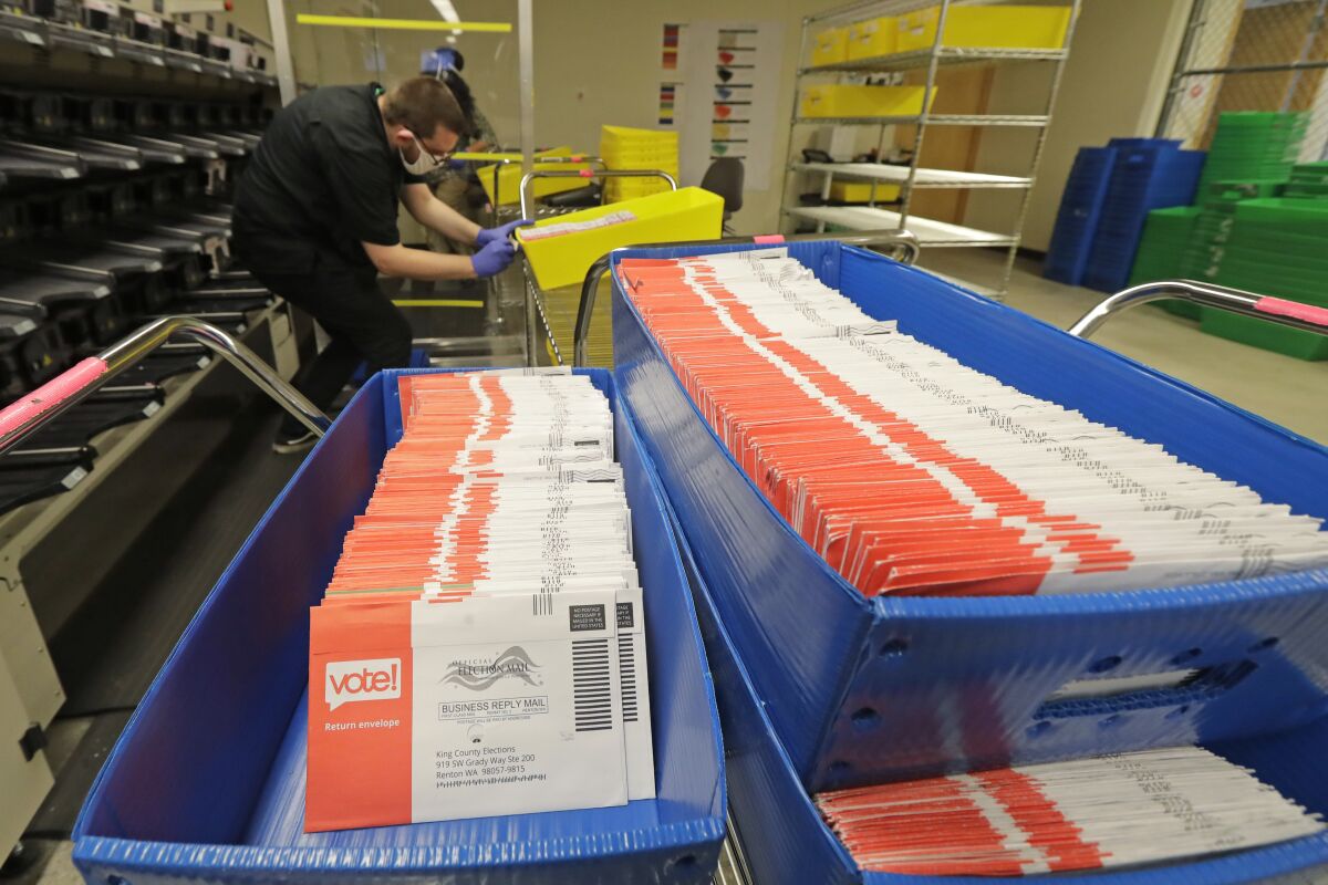 Vote-by-mail ballots are shown in sorting trays, Wednesday, Aug. 5, 2020, at the King County Elections headquarters in Renton, Wash., south of Seattle. Never in U.S. history will so many people exercise the right on which their democracy hinges by marking a ballot at home. (AP Photo/Ted S. Warren)