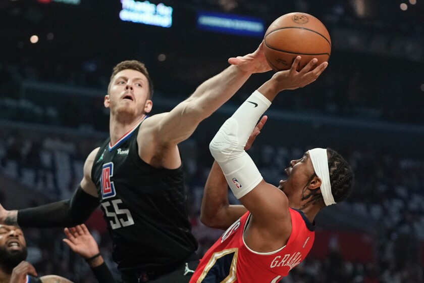 Clippers center Isaiah Hartenstein tries to block a shot by Pelicans guard Devonte' Graham.