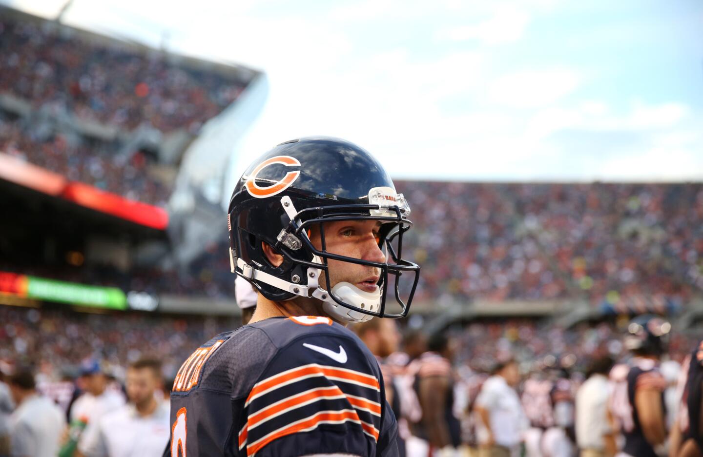 Jay Cutler pauses before heading into the game for the first offensive set in the first quarter of a preseason game against the Miami Dolphins.